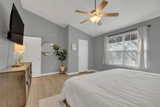 bedroom featuring vaulted ceiling, ceiling fan, and light hardwood / wood-style flooring