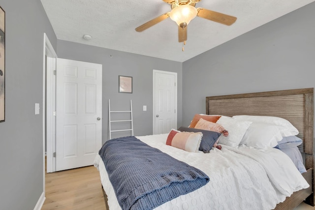 bedroom with ceiling fan and light hardwood / wood-style flooring