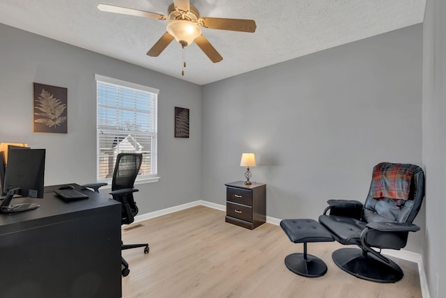 home office featuring ceiling fan, a textured ceiling, and light hardwood / wood-style flooring