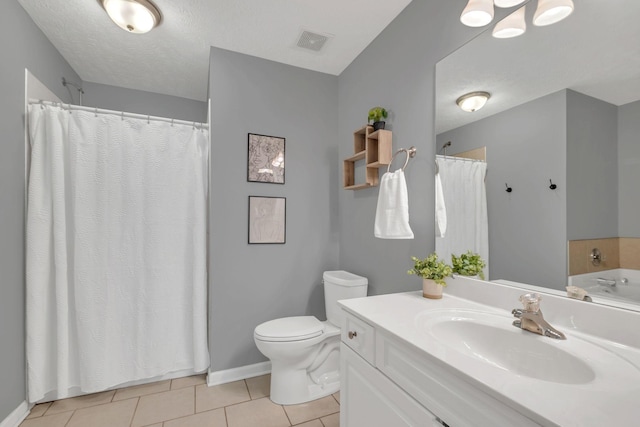 bathroom featuring a textured ceiling, toilet, tile patterned flooring, and vanity