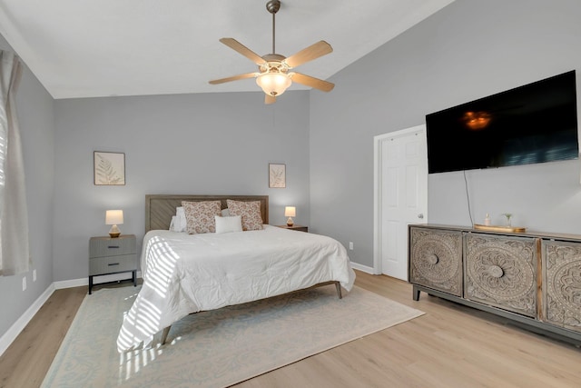 bedroom featuring ceiling fan, light wood-type flooring, and lofted ceiling