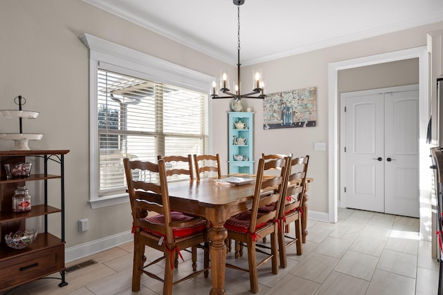 dining room featuring crown molding and a notable chandelier