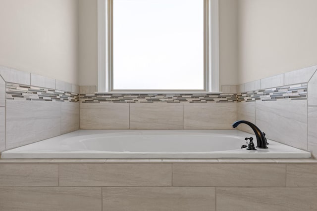 bathroom with tiled bath