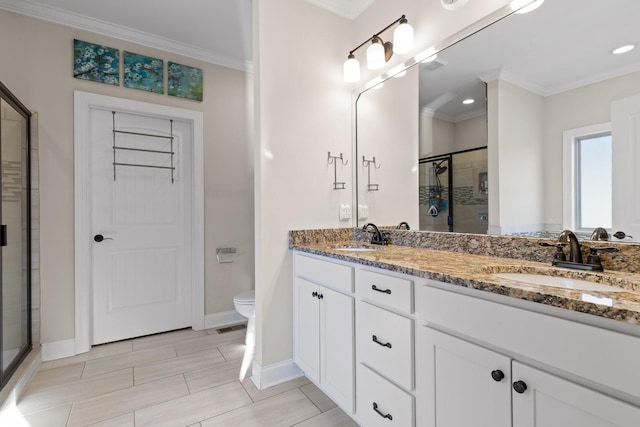 bathroom with an enclosed shower, vanity, ornamental molding, and toilet