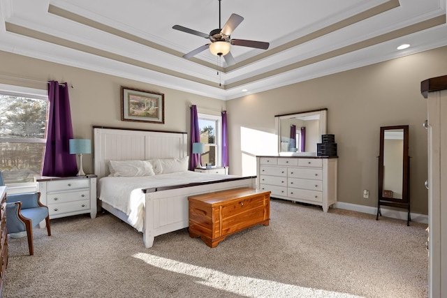 carpeted bedroom with ceiling fan, crown molding, and a raised ceiling