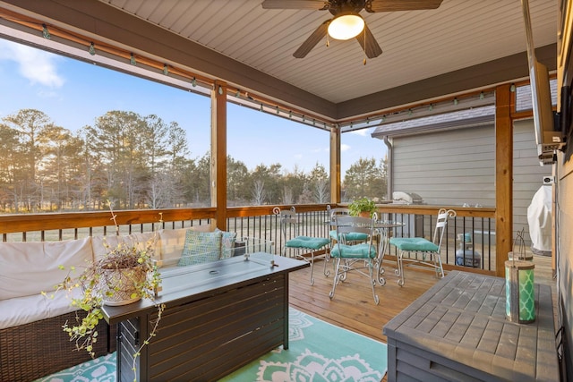 sunroom / solarium featuring ceiling fan