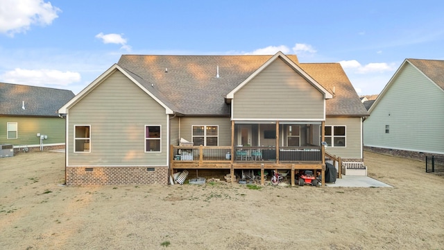 rear view of house with central air condition unit, a deck, and a sunroom