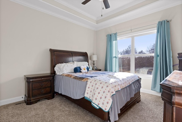 bedroom featuring ornamental molding, ceiling fan, a raised ceiling, and light colored carpet