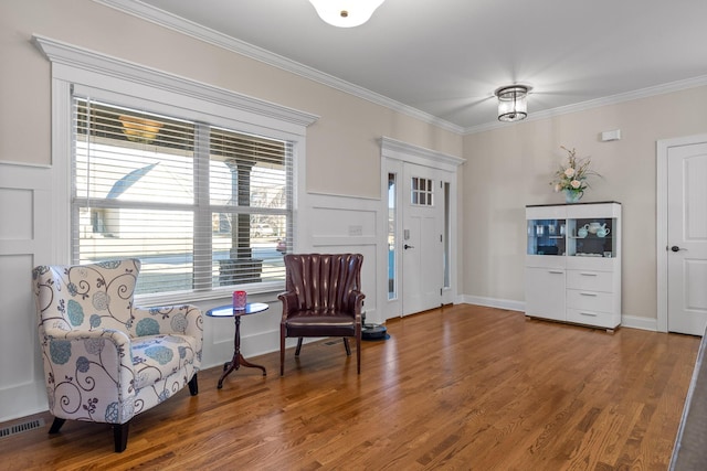 entryway with wood-type flooring and ornamental molding