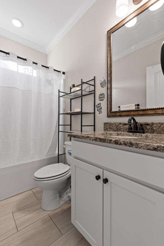 full bathroom featuring toilet, vanity, crown molding, and shower / bath combo