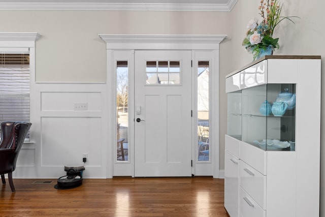 foyer featuring dark hardwood / wood-style flooring and ornamental molding