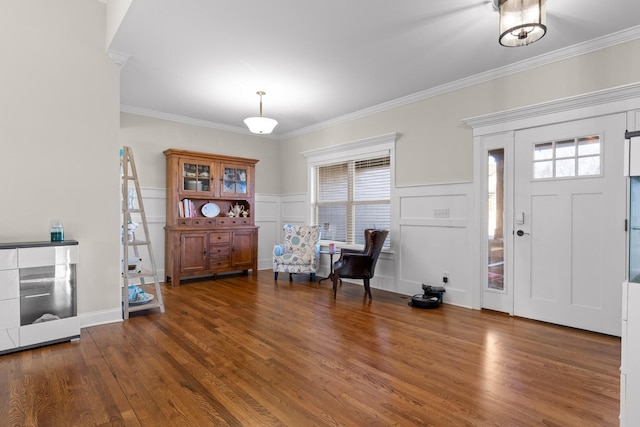 foyer entrance with dark hardwood / wood-style floors and ornamental molding