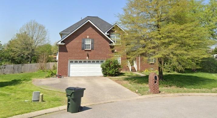 view of front of property featuring a garage and a front yard