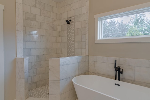 bathroom with tile walls and plus walk in shower