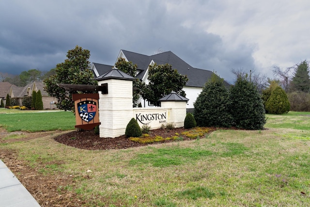 community sign featuring a lawn