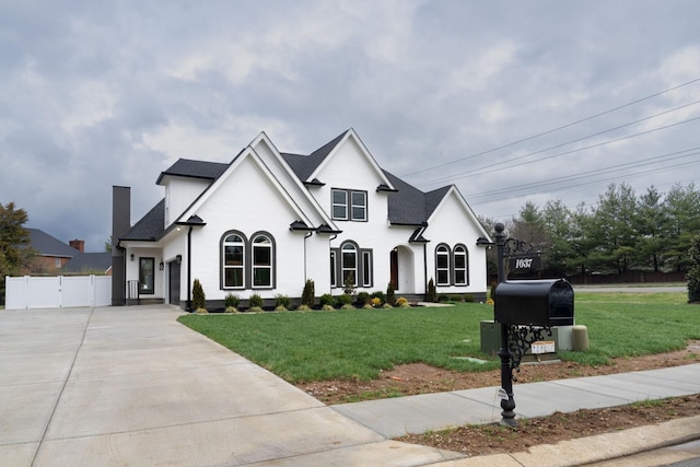 french provincial home with a front lawn