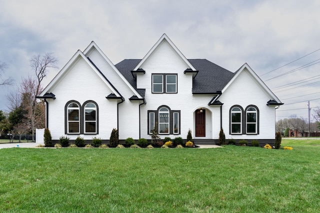 french country inspired facade with a front lawn