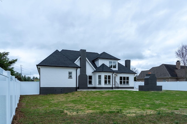 rear view of property with a patio area and a lawn