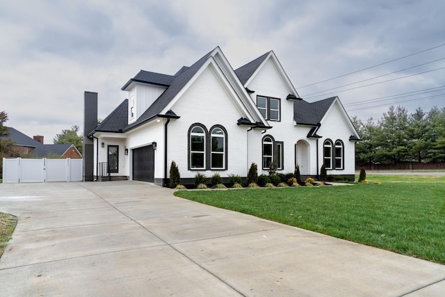 french country style house with a front yard and a garage