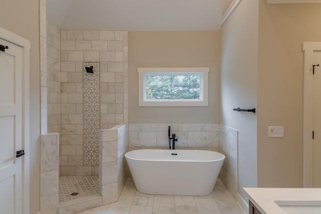 bathroom with a bath, tile walls, and vanity