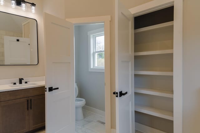 bathroom with vanity and toilet