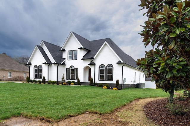 french country inspired facade with cooling unit and a front lawn