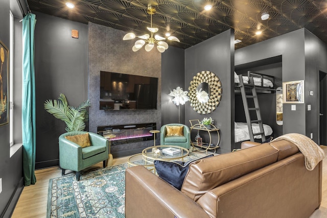 living room featuring wood-type flooring and a notable chandelier