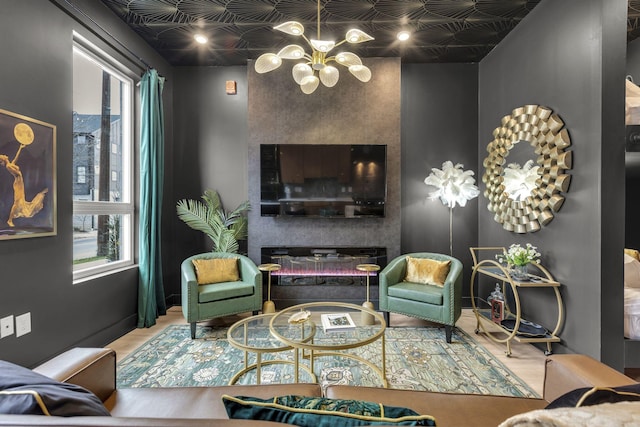 living room featuring a large fireplace and an inviting chandelier