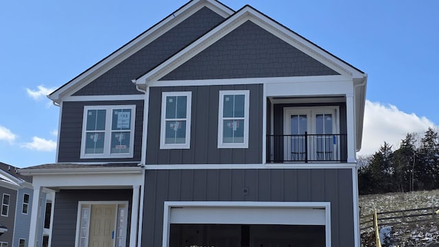 craftsman-style home with a garage and fence