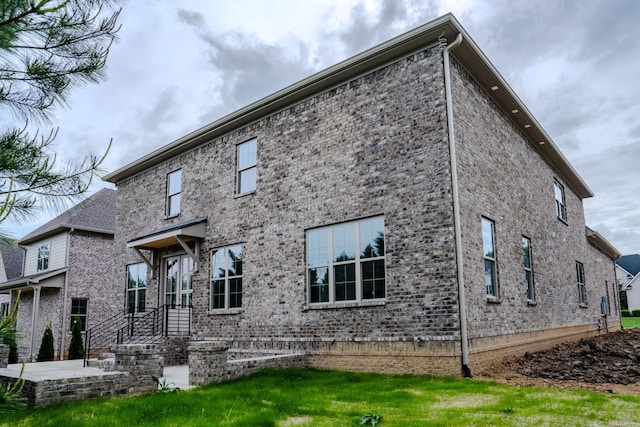 rear view of house featuring a lawn