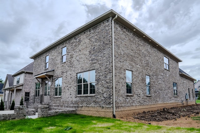 rear view of property featuring a lawn