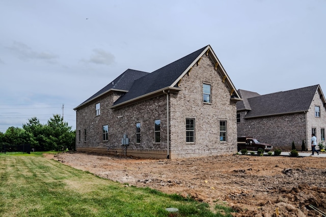 view of side of home with a yard