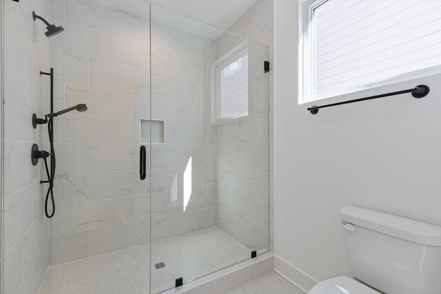 bathroom with toilet and an enclosed shower