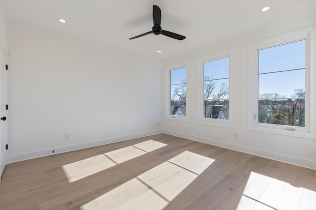 spare room featuring ceiling fan and light hardwood / wood-style flooring