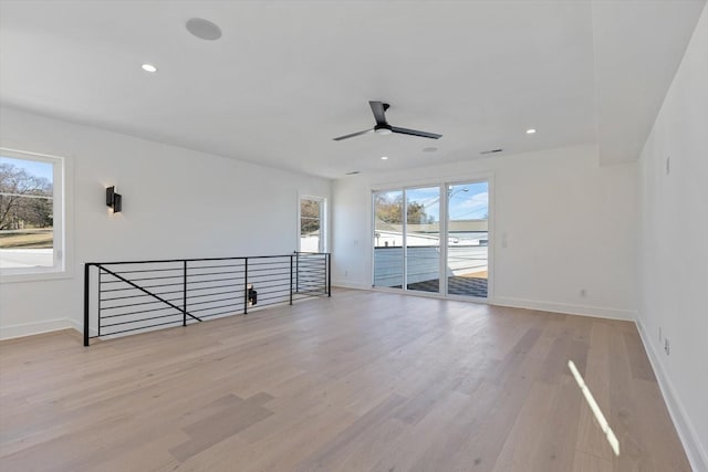 empty room featuring light wood-type flooring and ceiling fan