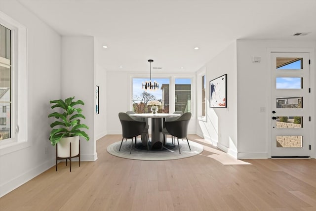 dining space featuring a chandelier and light hardwood / wood-style flooring