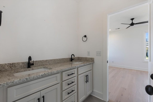 bathroom with vanity, ceiling fan, and wood-type flooring