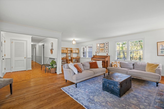 living room with hardwood / wood-style floors and ornamental molding