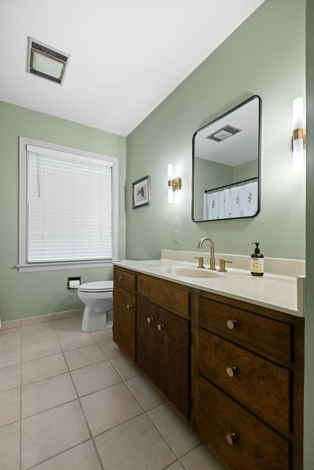 bathroom featuring toilet, tile patterned flooring, and vanity