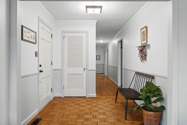 hall with crown molding and light parquet flooring