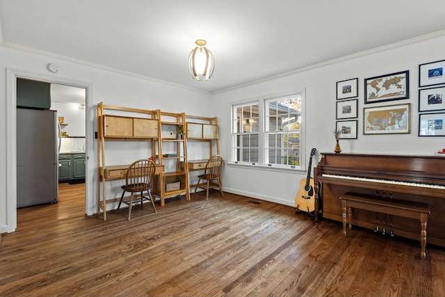 office area with dark wood-type flooring and crown molding