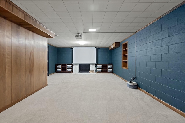 carpeted cinema room featuring a brick fireplace