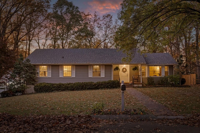 ranch-style house featuring a lawn