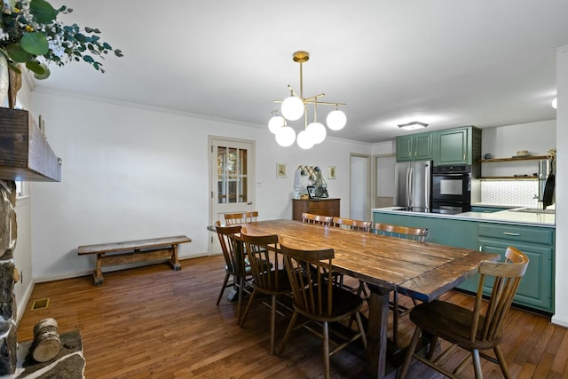 dining room featuring crown molding, a chandelier, and dark hardwood / wood-style flooring