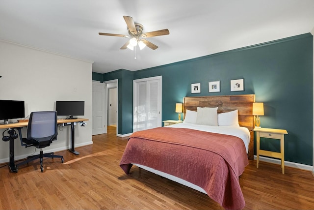 bedroom with light wood-type flooring, a closet, and ceiling fan