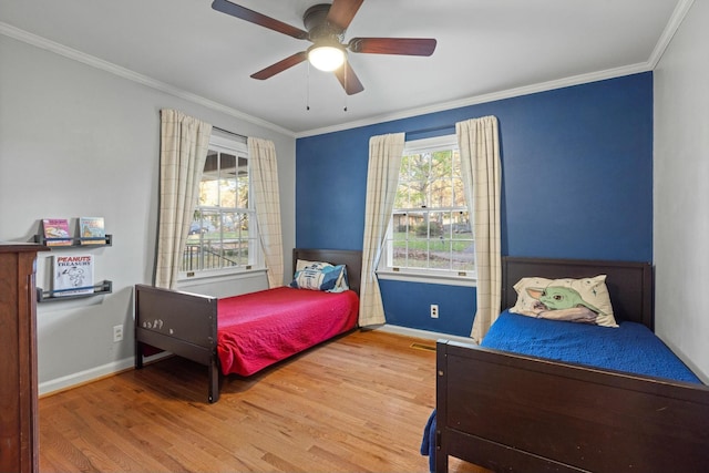 bedroom with ceiling fan, crown molding, and hardwood / wood-style flooring