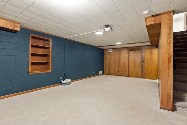 basement featuring light colored carpet