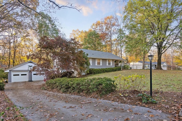 view of front of house with a garage and an outbuilding