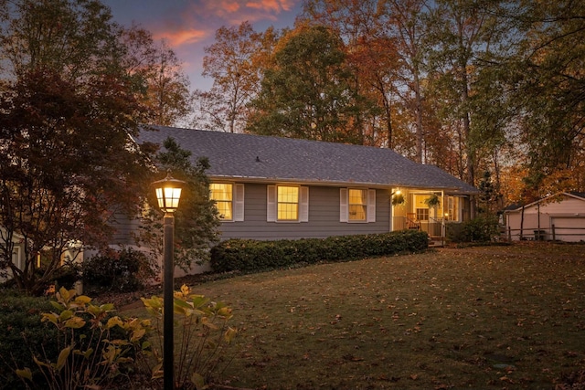 ranch-style house featuring a lawn