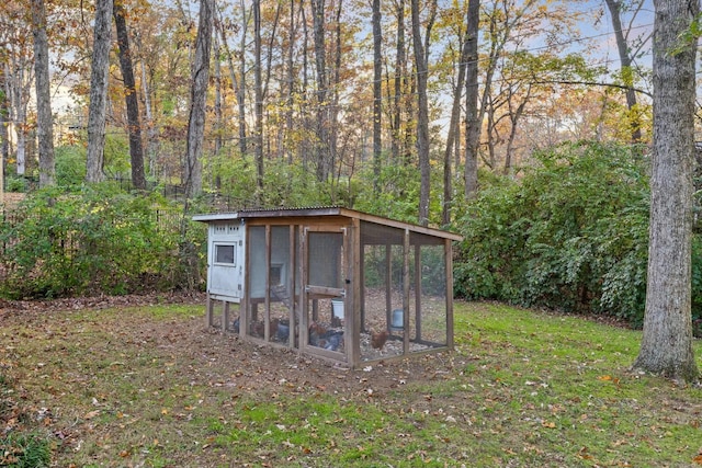 view of outdoor structure featuring a lawn